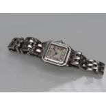 CARTIER: A Santos lady's quartz steel bracelet watch, case back no 13200c 000010, no box,