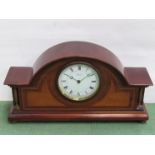 An Edwardian mahogany and inlaid mantel clock with brass bezel, bun feet and spindle columns,