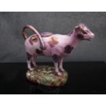 A Staffordshire pink lustre cow creamer, 16.