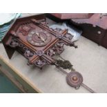 A circa 1900 cuckoo clock with weights and pendulum