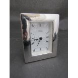 A Harrods silver framed desk clock with quartz movement,