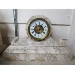 A white marble mantel clock, Roman numerated chapter ring, key and pendulum,