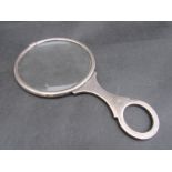 A silver magnifying glass,