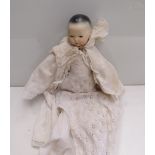 A 12" bisque headed baby doll with sleepy eyes, in long white dress, marked "1" to back of head,