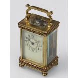 A late 19th/early 20th Century French brass carriage clock with Arabic enamelled dial,