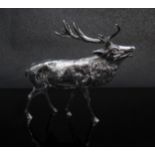 A silver figure of a baying stag,