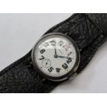 OMEGA: An early 20th Century silver cased trench watch, white enamel dial a/f with Arabic numerals,