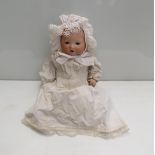 A 15" tall Armand Marseille bisque headed doll in white dress and bonnet, marked "351.