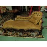An early Victorian rosewood chaise longue with floral carved and scrolled details on castors,