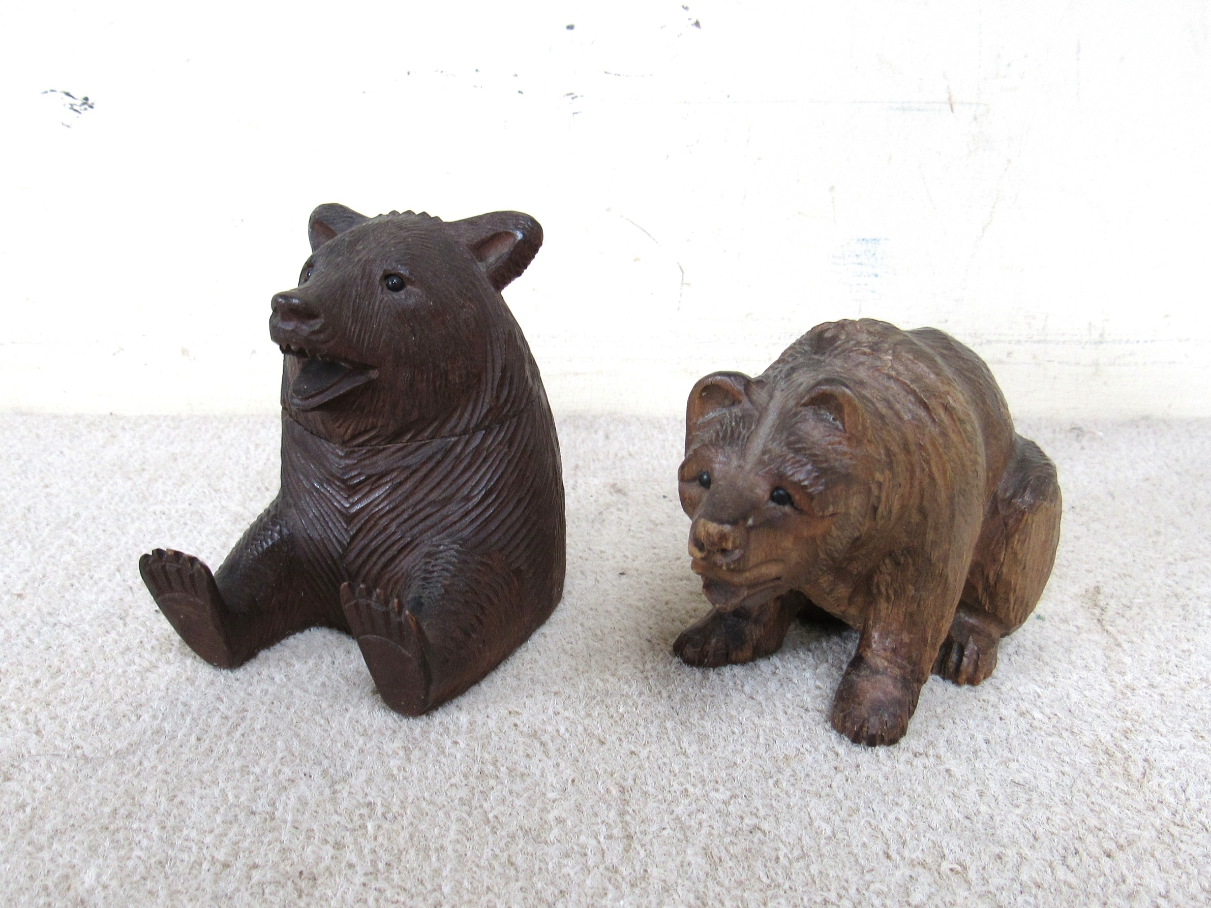 A Black Forest bear as an inkwell with associated glass inkwell and a seated example (2)