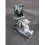 A painted cast iron metal money box depicting terrier chasing a cat