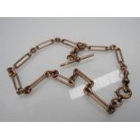 A 9ct rose gold watch chain with T-bar