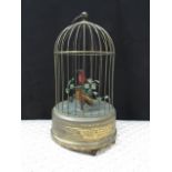 An early to mid 20th Century clockwork automaton birdcage with two birds on branches,