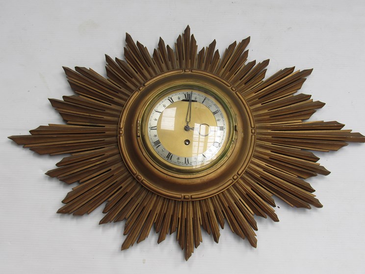 A gilded sunburst from wall clock with brass dial and silvered Roman chapter ring,