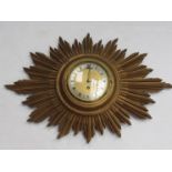 A gilded sunburst from wall clock with brass dial and silvered Roman chapter ring,