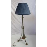 An Art Nouveau brass height extending standard lamp and shade