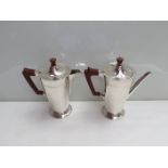 A Roberts and Belk silver coffee pot and matching hot water pot with carved handles and knops,