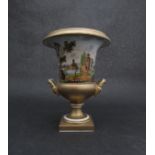 An early 19th Century porcelain twin handled urn form vase with applied gilding and landscape scene,
