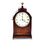 An early 19th Century mahogany bracket clock with brass inlay, bezel, finial, pierced side frets,