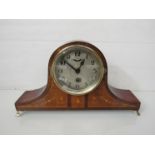 A mahogany and inlaid Napoleon hat form mantel clock with drum movement, Arabic silvered dial, key,