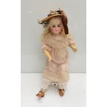 A late 19th Century bisque socket fully jointed doll,