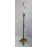 A gilt relief and velvet column standard lamp the circular raised base over scroll feet