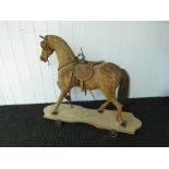 A 19th Century straw filled, wooden body horse skin sit on horse on wheeled wooden base,