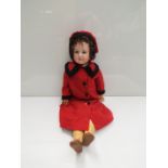 An Armand Marseille 28" bisque head, compostion girl doll in red woollen coat and hat,