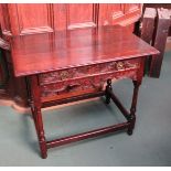 Circa 1780 a carved oak side table the single frieze drawer over turned legs joined by stretchers