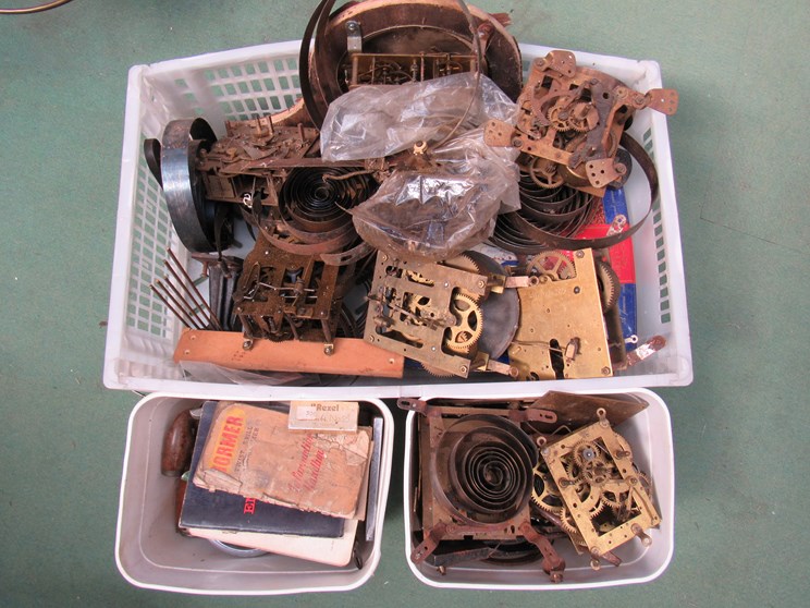 Three boxes of clock movements, spares,