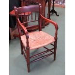 Circa 1820 a fruitwood elbow chair with spindle decoration the rushed seat and turned supports