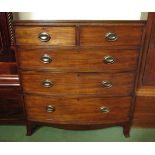 A crossbanded mahogany bow front chest of two short over three graduating long drawers on outswept