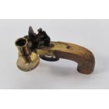A table candlestick holder in the form of a flintlock pistol
