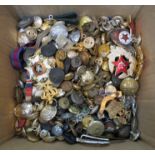 A mixed box containing cap badges, military buttons, medal ribbons,