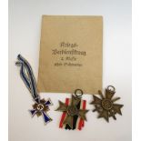 A German Mother's medal, a war merit cross with swords and a war merit medal,