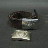 A Third Reich era leather belt with embossed buckle depicting a Swastika,