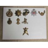 Nine military badges including NFS, Royal Artillery, etc,