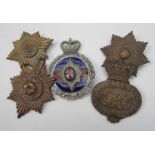 Five badges including Victorian helmet badge and enamelled car badge (a/f)