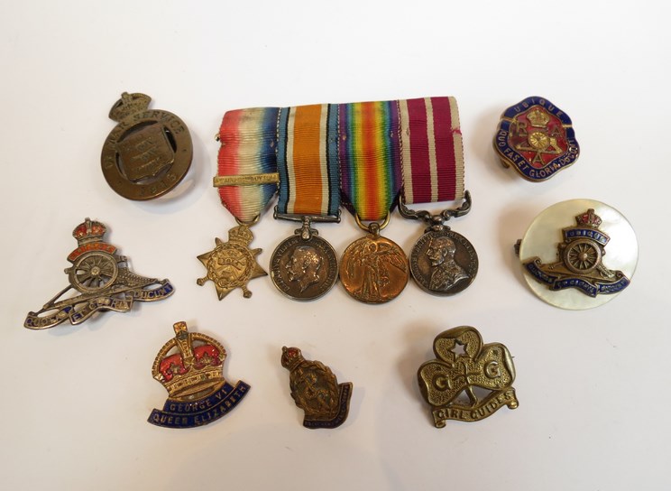 A quantity of military badges including "On War Service 1915" Ordnance,