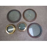 Five brass port holes, consisting of one pair and three larger matching examples,