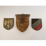 A German pattern Krim campaign badge and two helmet shield badges (3)