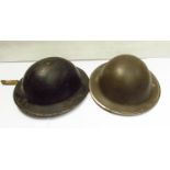 Two WWII British type II helmets, one blackened for civil use,