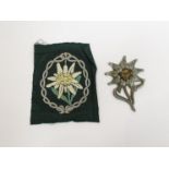 A German Edelwiess cloth arm badge and an Edelwiess cap badge (2)