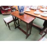 An Arts and Crafts oak hall table the pierced end base over sledge feet joined by a flat stretcher