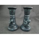 A pair of brass frog candle sticks with verdigree finish