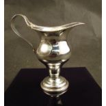 A Barker Brothers silver cream jug, gadrooned edge on circular base Chester 1908,