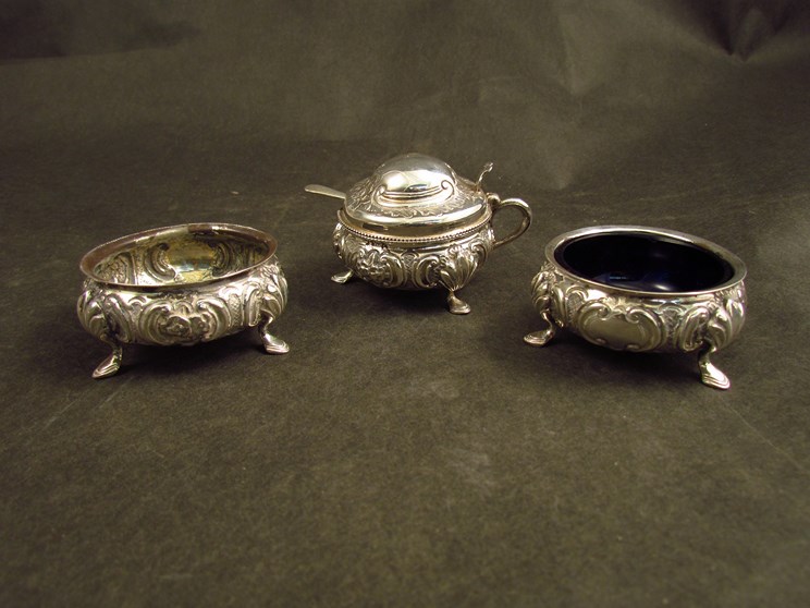 A Josiah Williams silver three piece cruet comprising two salts and a mustard, Exeter 1857,