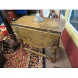 A near pair of oak drop-leaf occasional tables