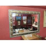 A large bevel edge wall mirror with foliate border,