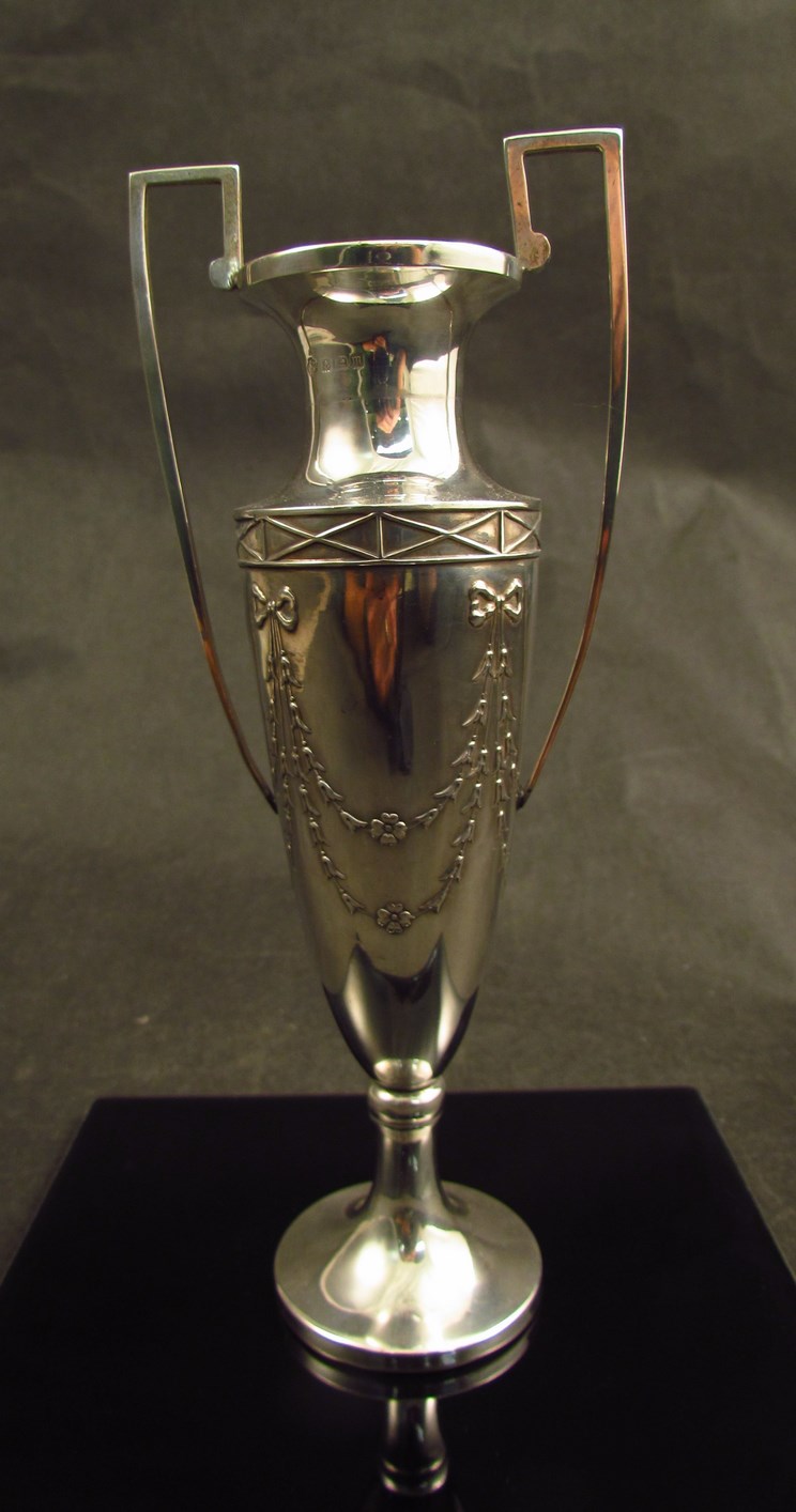 A William Hutton and Sons Ltd silver twin handled stem vase, with ribbon and floral swag detail,